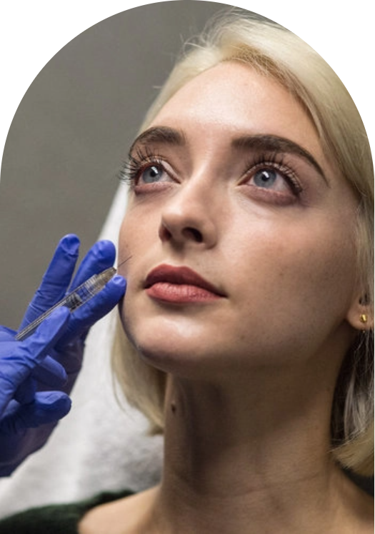 A woman receiving a Juvederm facial treatment with a needle