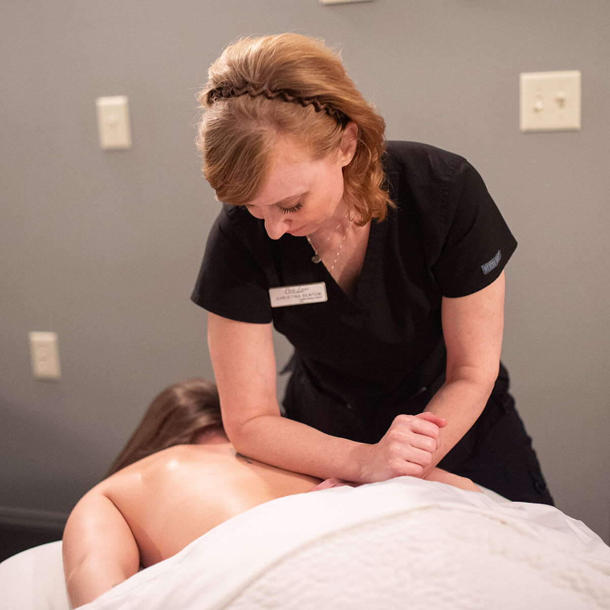 A woman receiving a massage in a serene room at a spa in Knoxville.